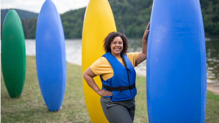 Woman smiling with paddleboards