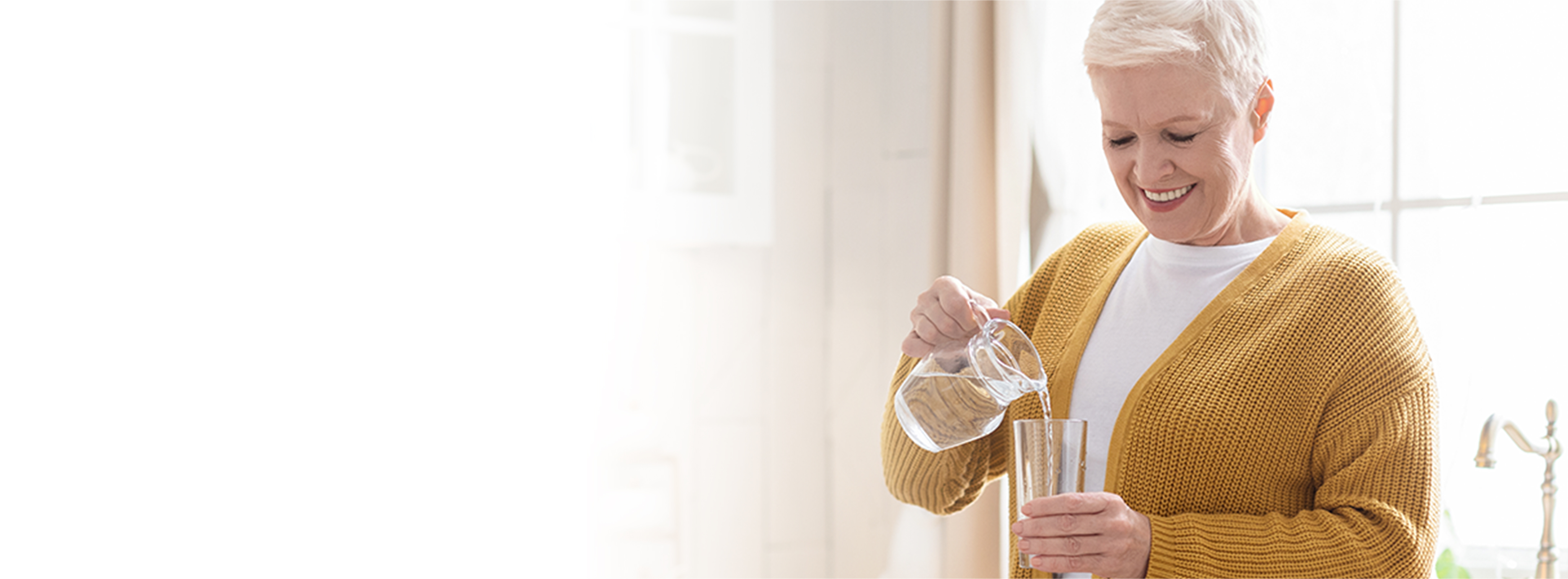 woman pouring a glass of water