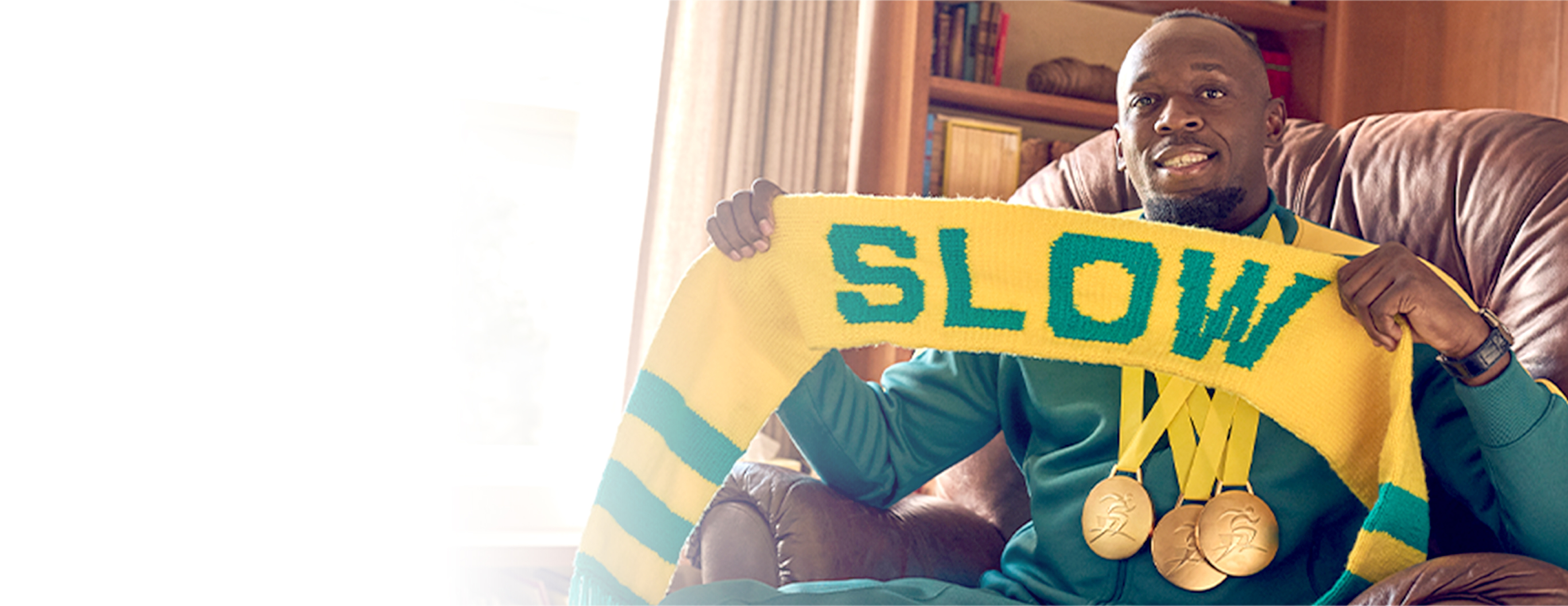 Usain Bolt holding a scarf that says slow